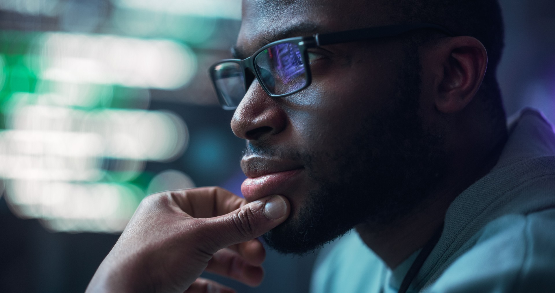 Close Up Portrait of Male Programmer Developing New Software, Coding, Managing Cybersecurity Project. Black Man Working on Computer, Lines of Code Language Reflecting on his Glasses